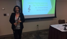 Christine Damm poses with clarinet at a seminar she presented at.