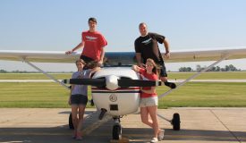 Students posing on QU Aviation plane