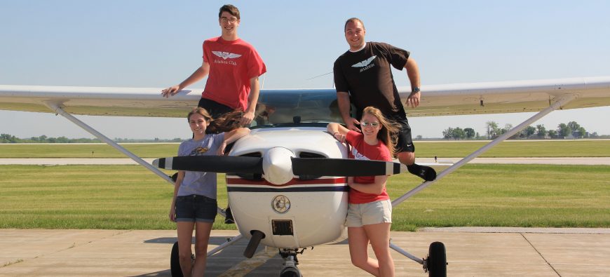 Students posing on QU Aviation plane