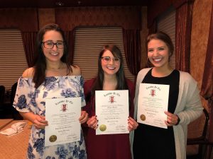 3 students holding up Lambda Pi Eta certificates