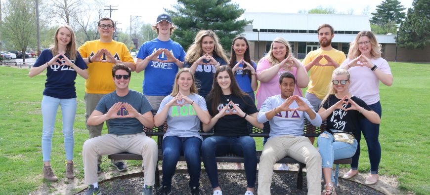 Greek life students making Greek symbols