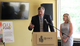Man and woman giving a speech at Quincy University