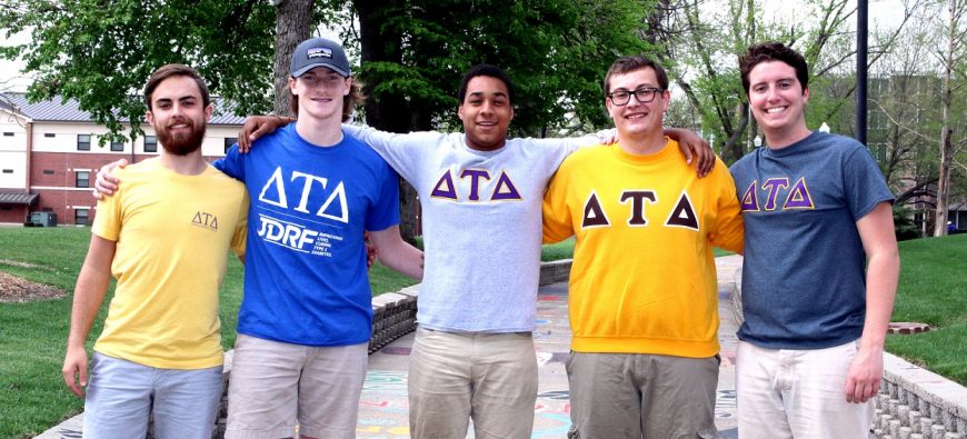 Some guys standing on Penny Lane representing their Greek life