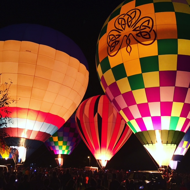 Some hot air balloons lit up on Friars Field