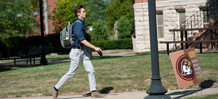 Student walking by Francis Hall