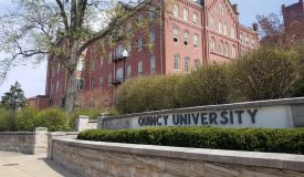 QU Sign and Francis Hall in Spring, West View