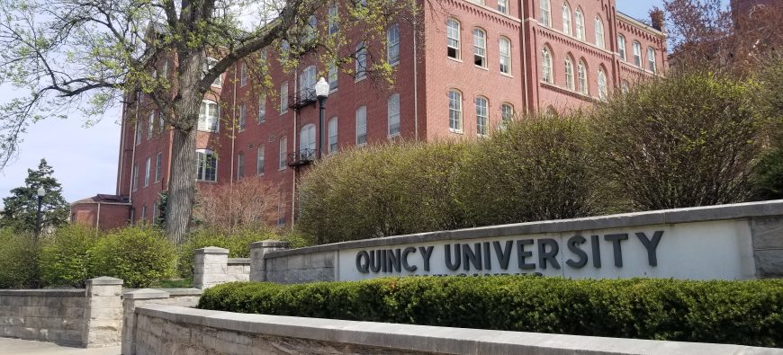 QU Sign and Francis Hall in Spring, West View