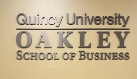 QU Oakley School of Business Sign