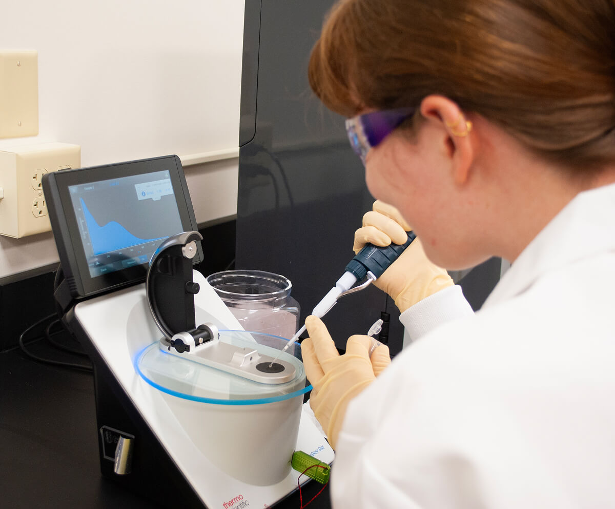 Student using pipette for analysis