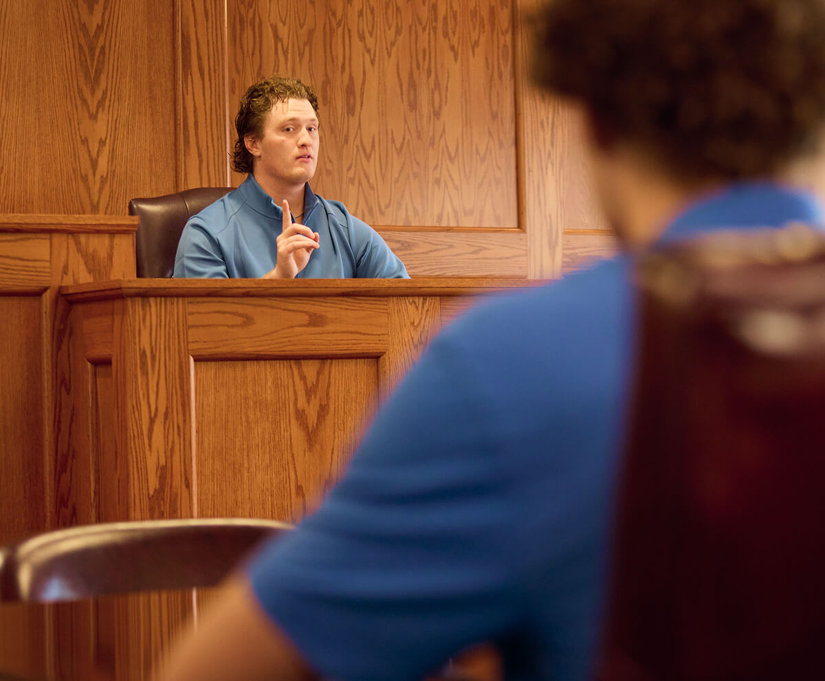Behind the shoulder shot of student on witness stand in a mock trial