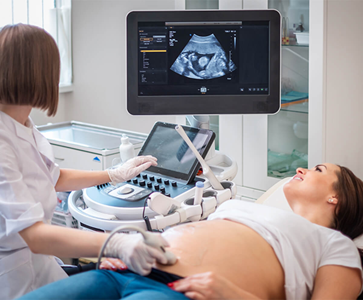 Doctor with patient performing sonogram