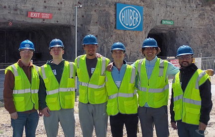 group of students in green safety vests infront of Huber underground mine entrance
