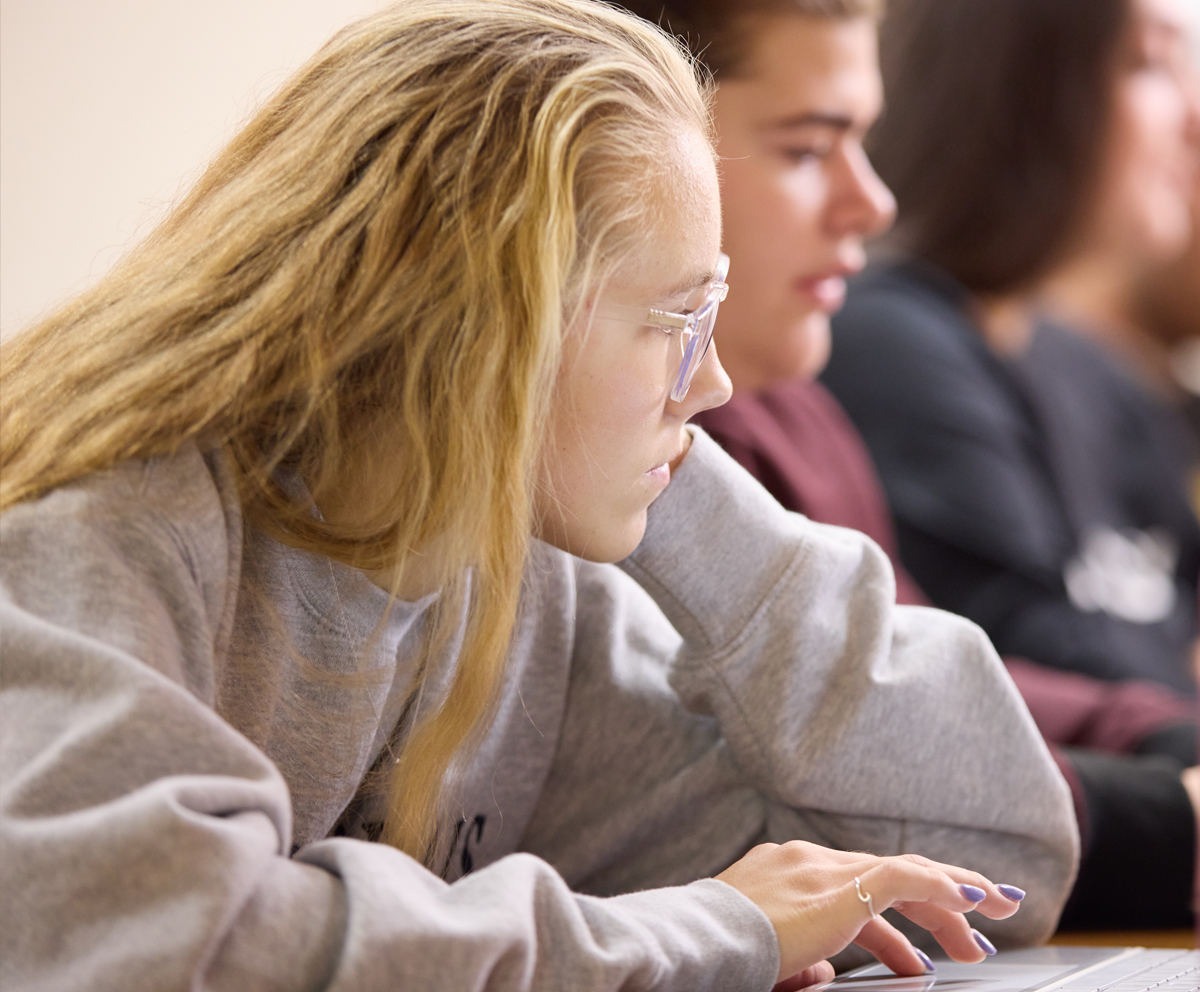 female student looking at her laptop