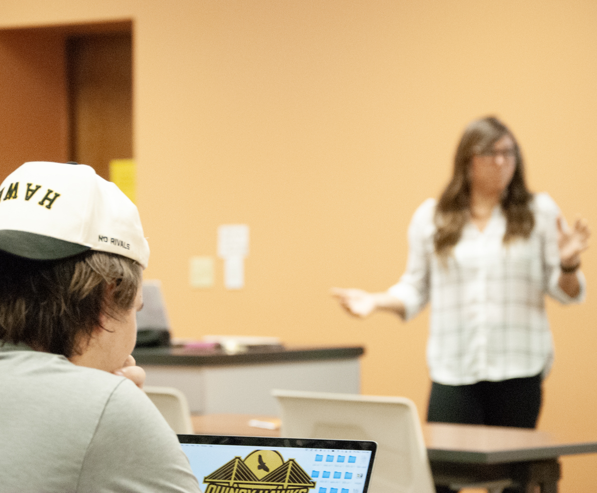 student listening to instructor teaching sport management infront of the class