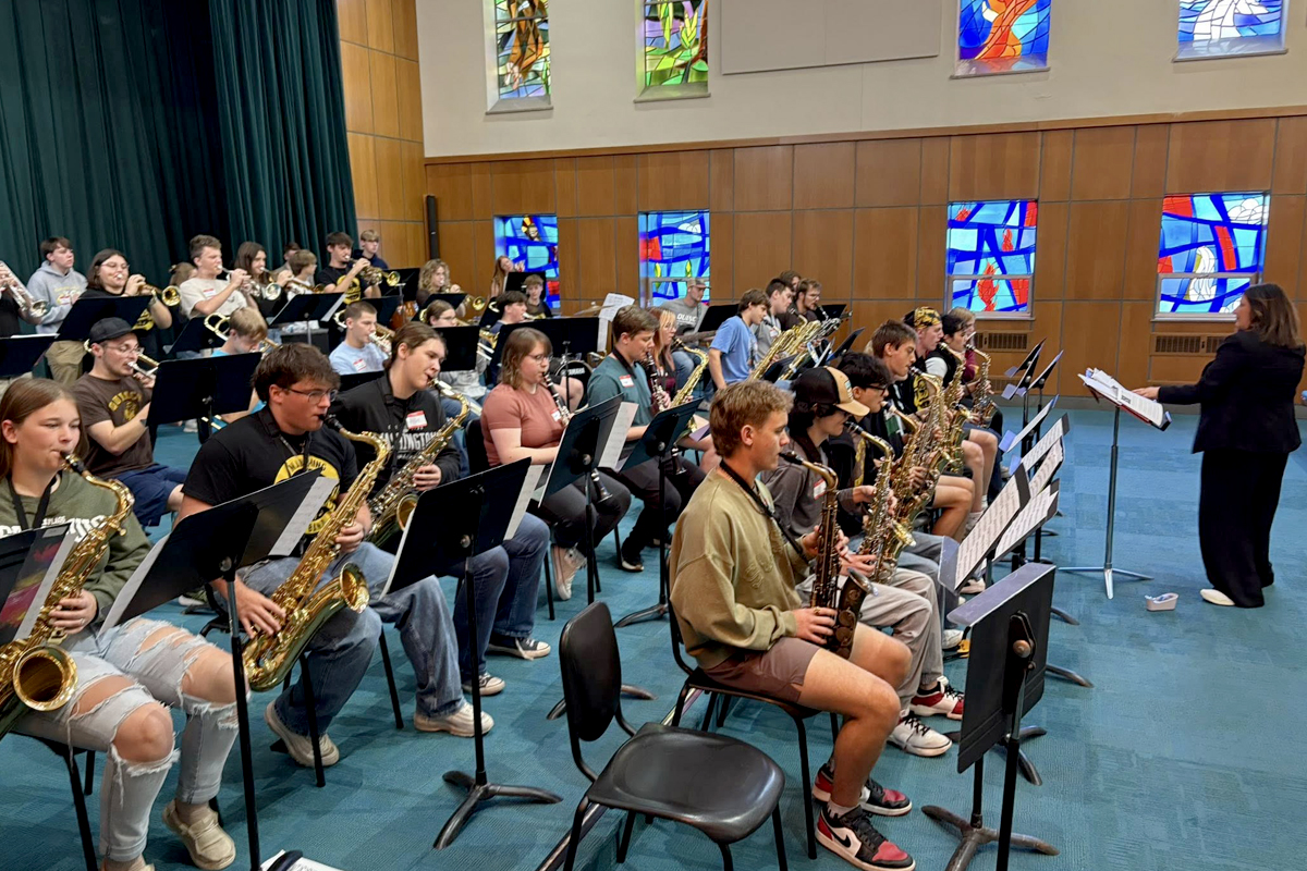 Highschool students playing in a band together on a Music visit day to QU