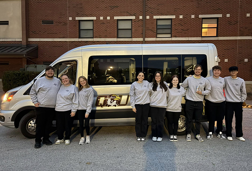 QU music students infront of QU van