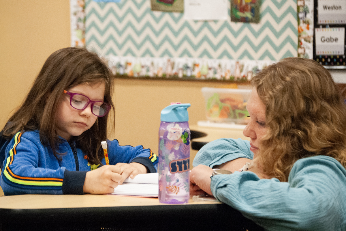 Education student helping a grade school student