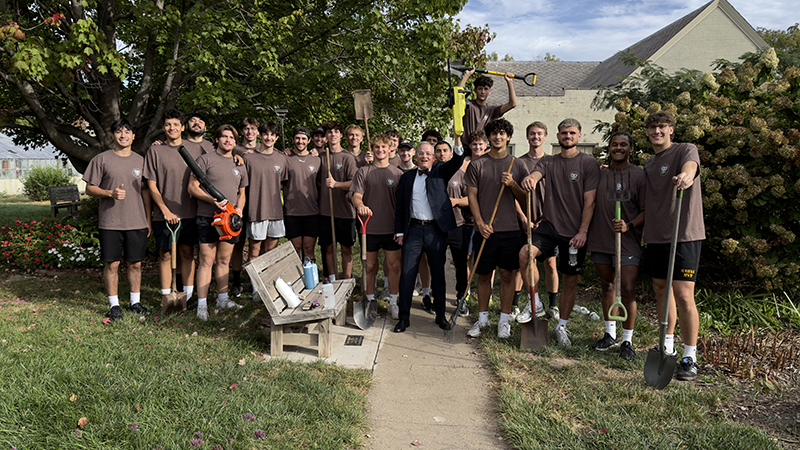 group photo of students with Dr. McGee volunteering for Day of service