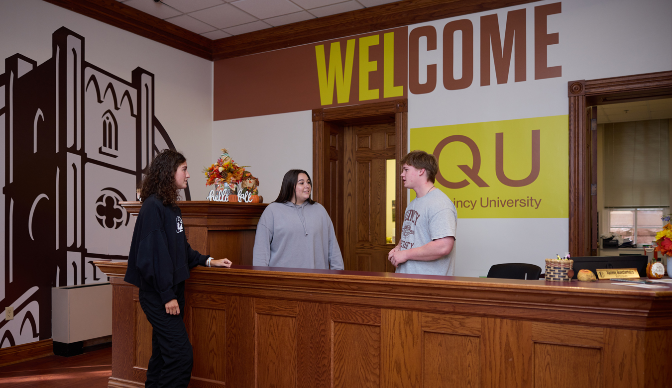 Welcome Desk with students talking