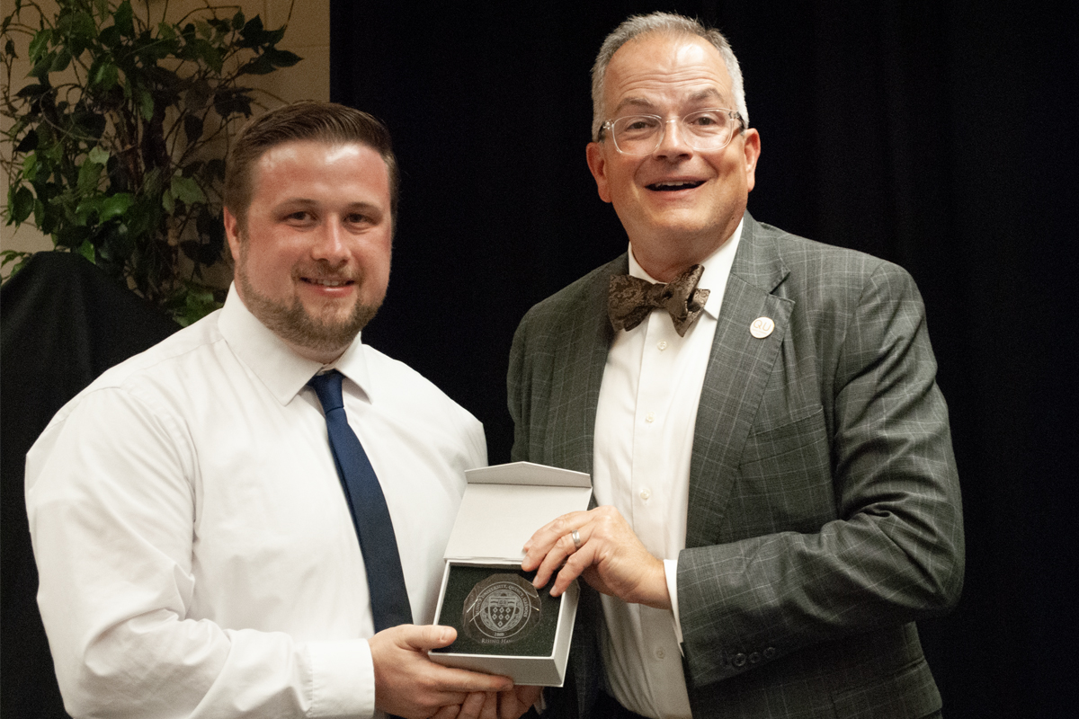 Alumni award being presented to an alum from the president