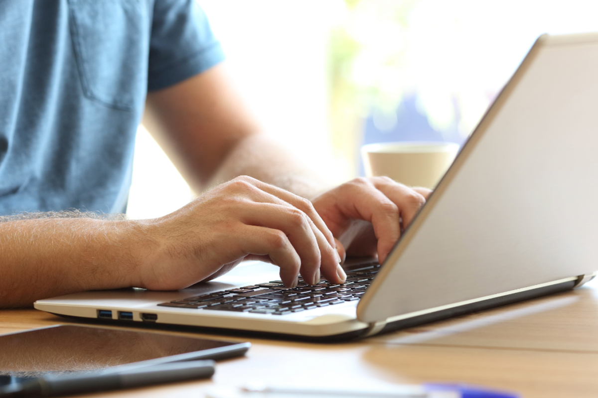 hands typing on a keyboard