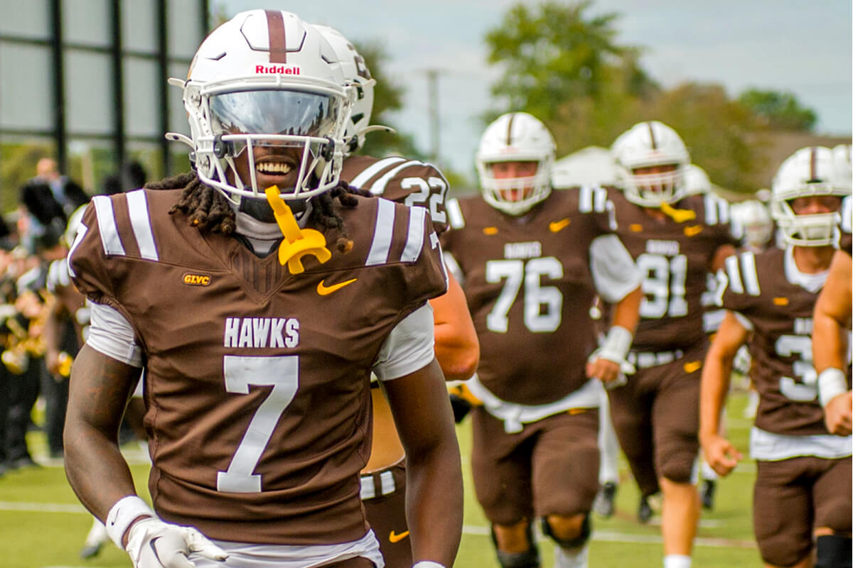 Hawks football team running onto field