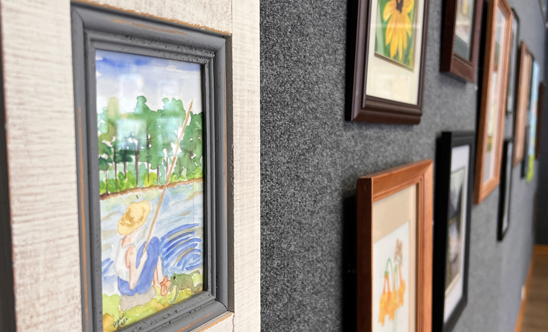 framed watercolor artwork on the wall in the gray gallery