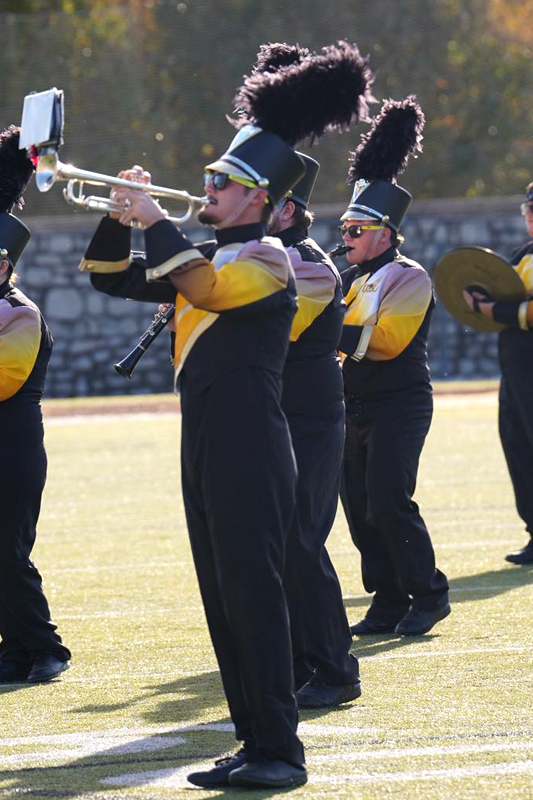Trumpet player on the field with marching band