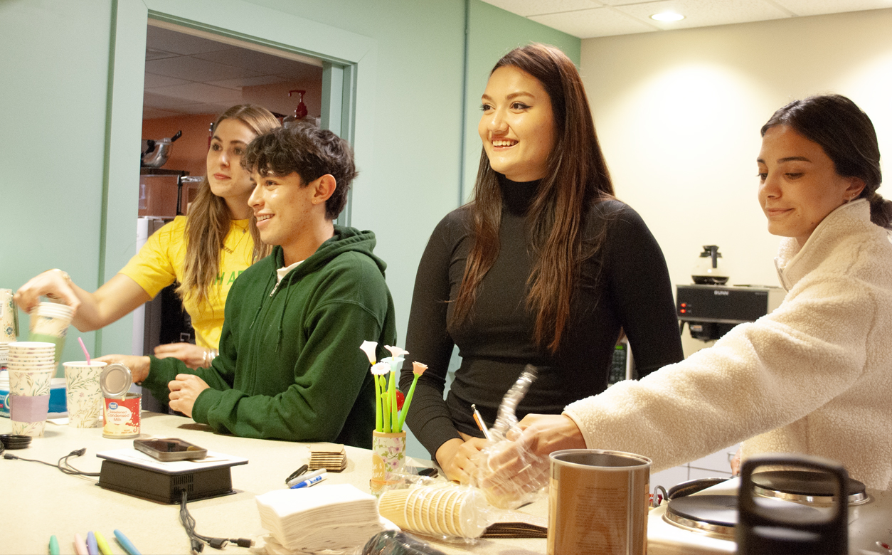 International students serving coffee on campus