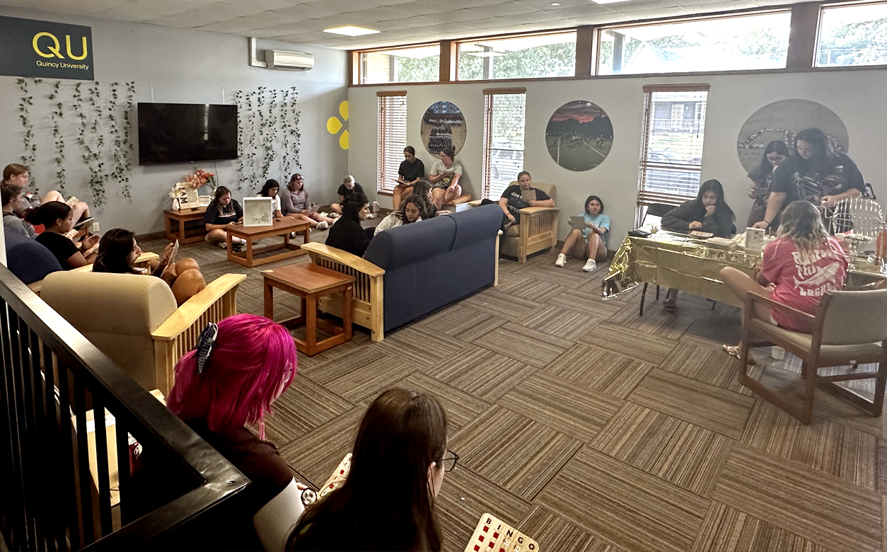 girls in lounge of dorm hall playing bingo