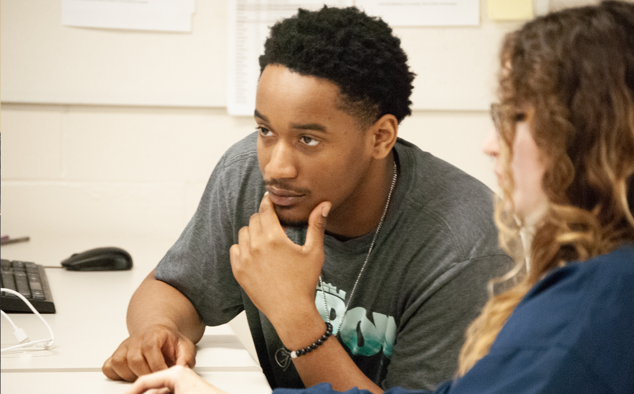 two students looking at a monitor