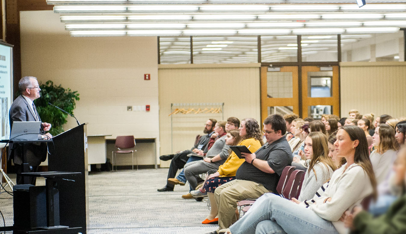 President McGee speaking to a group of QU Honors students