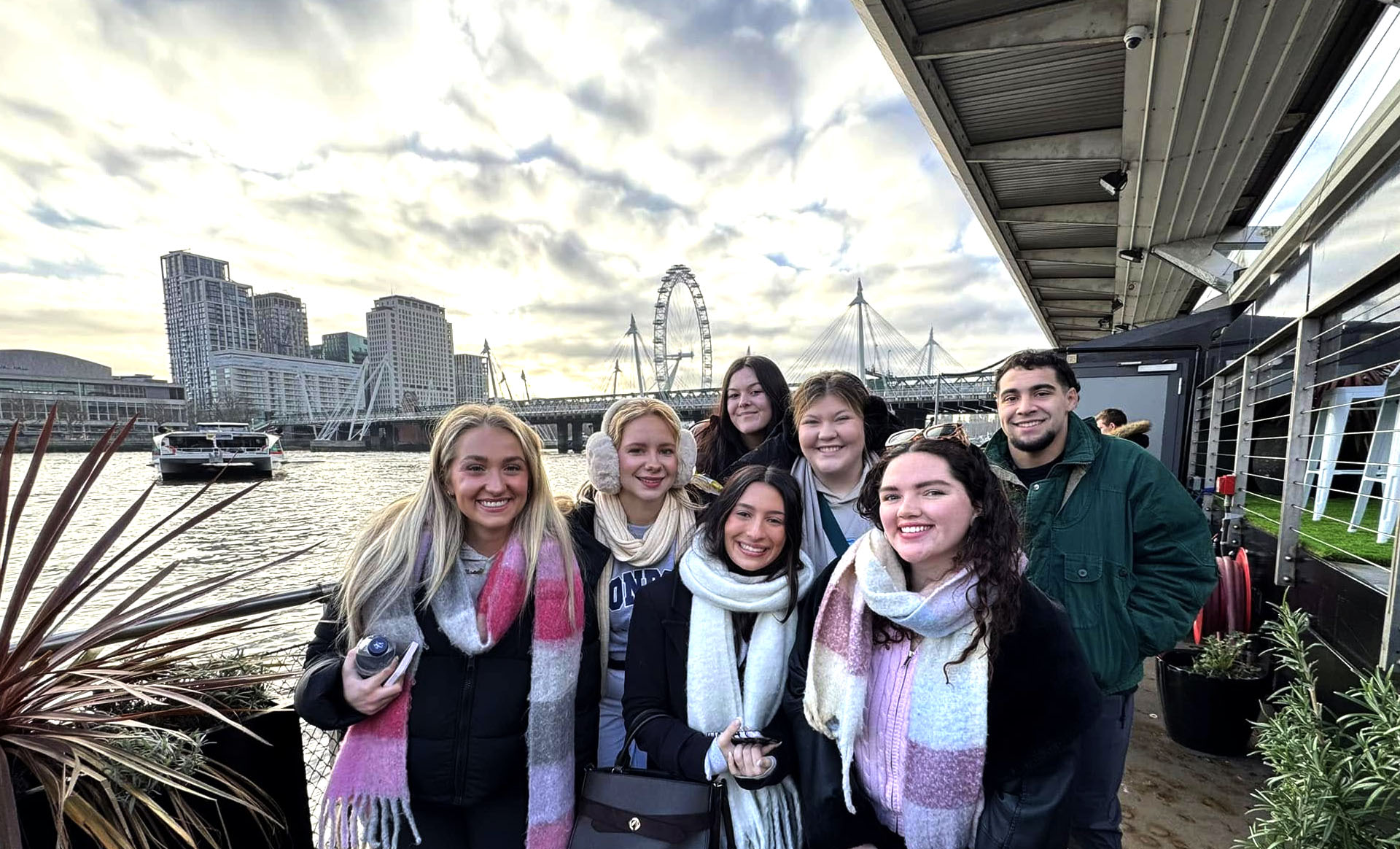QU students in London infront of the Eye and river.