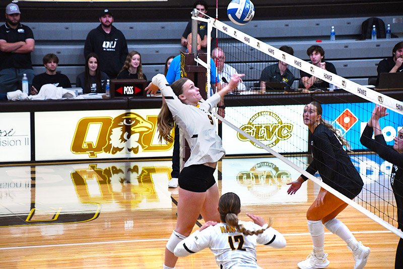 Women's volleyball player setting up a play