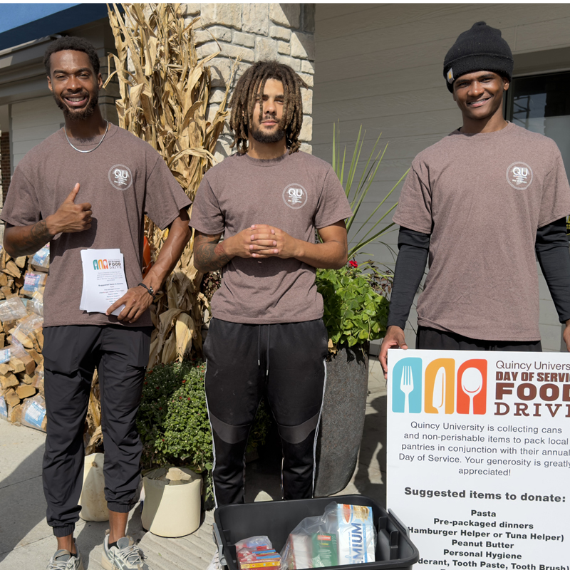 3 males at a food drive for day of service