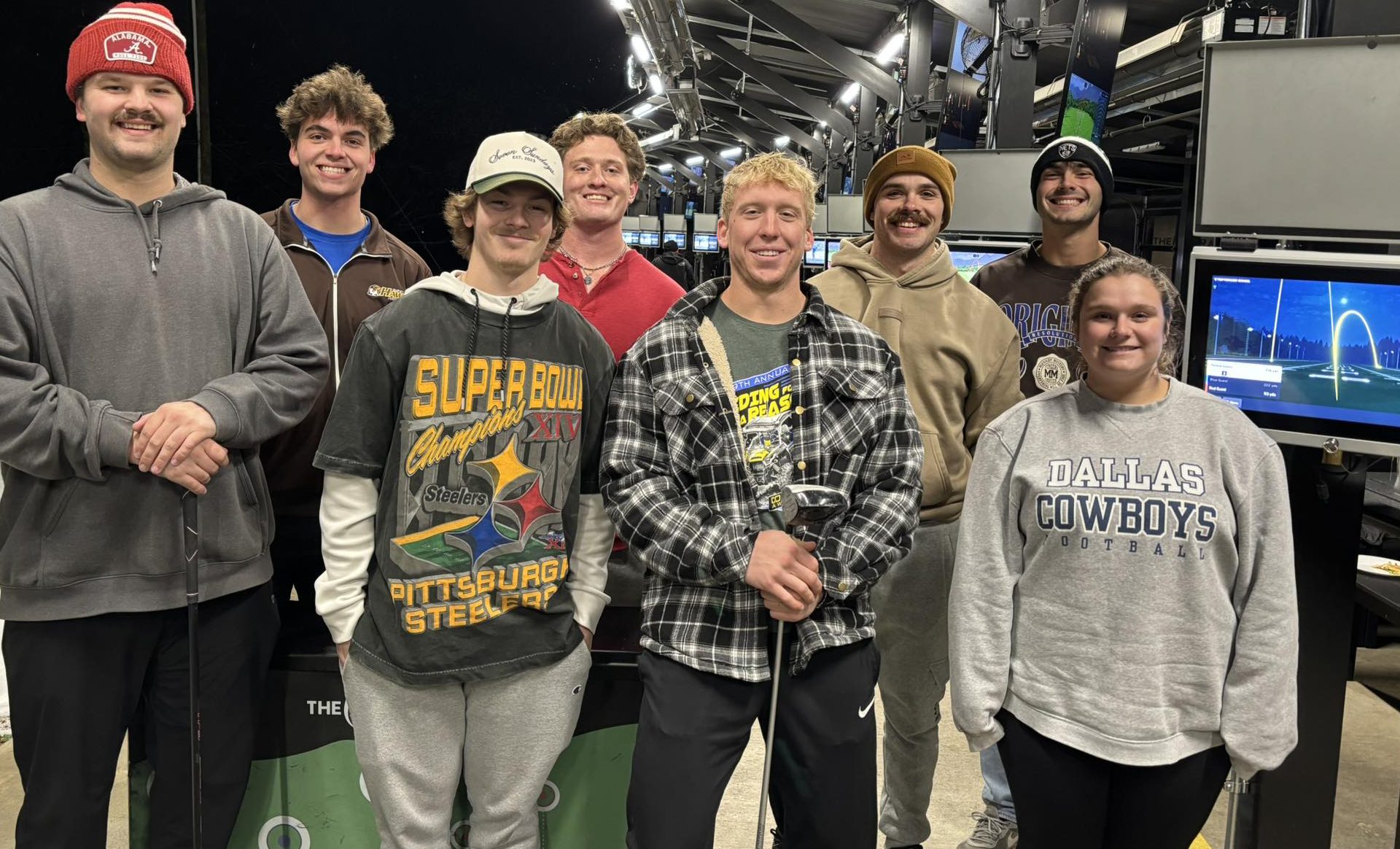 students in a group at a driving range