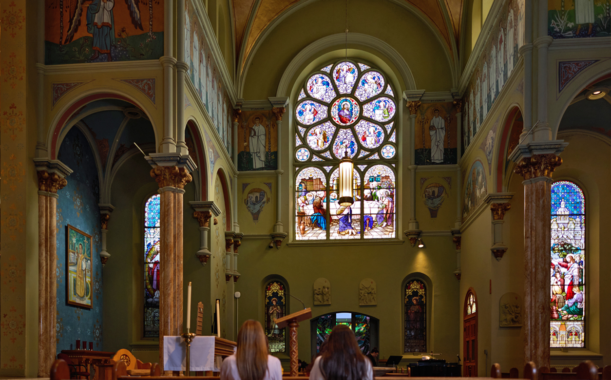 two femail students praying in the chapel