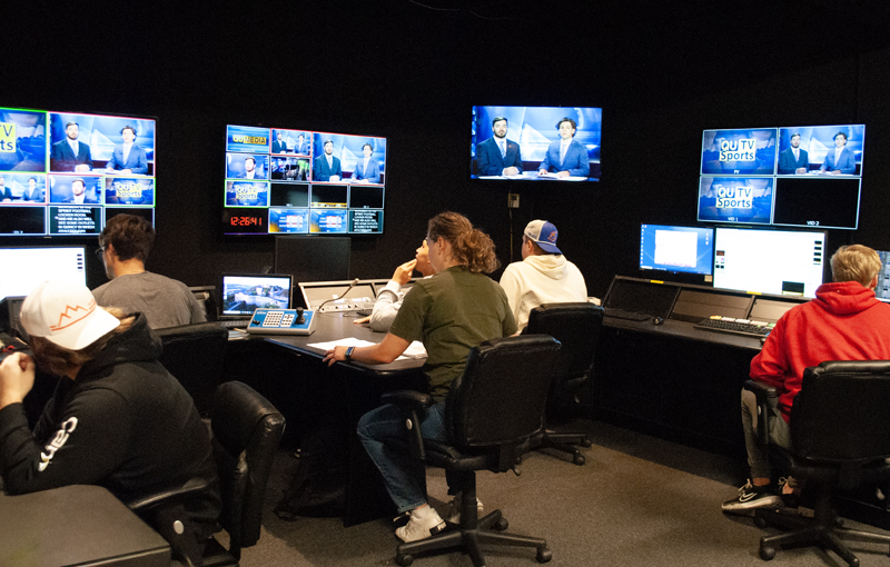 Students in campus tv control room directing the news