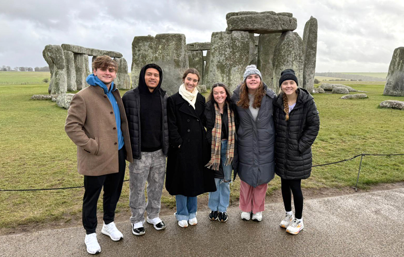 Students standing in front of Stone henge