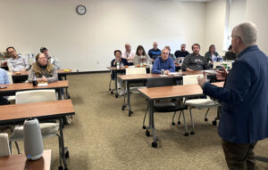 Group of professors in a classroom listening to a guest speaker