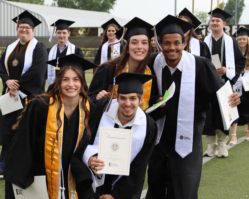 group posing for photo at graduation