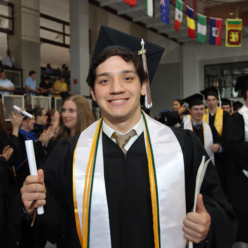 Male grad holding diploma