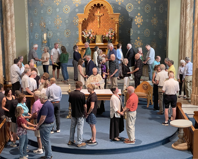 Alumni at mass renewing their vows