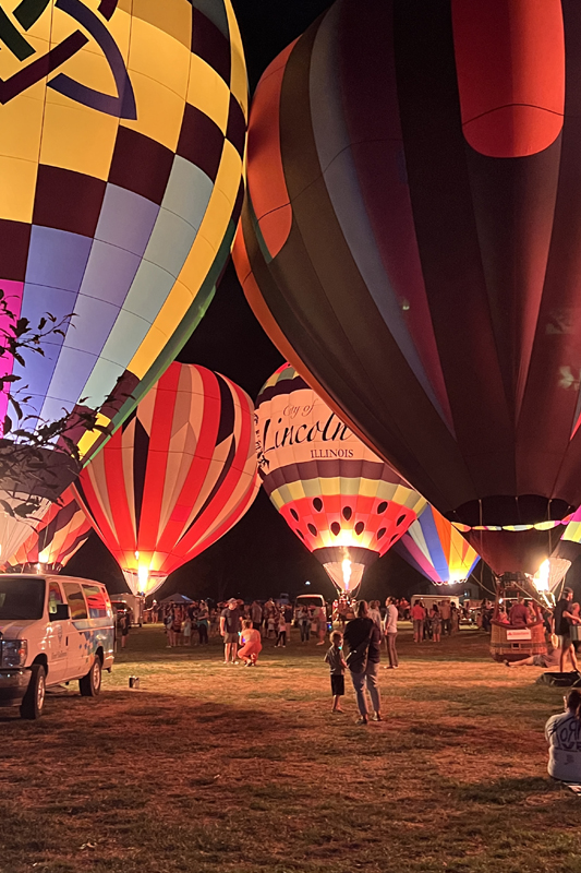 hot air balloons glowing on friars' field