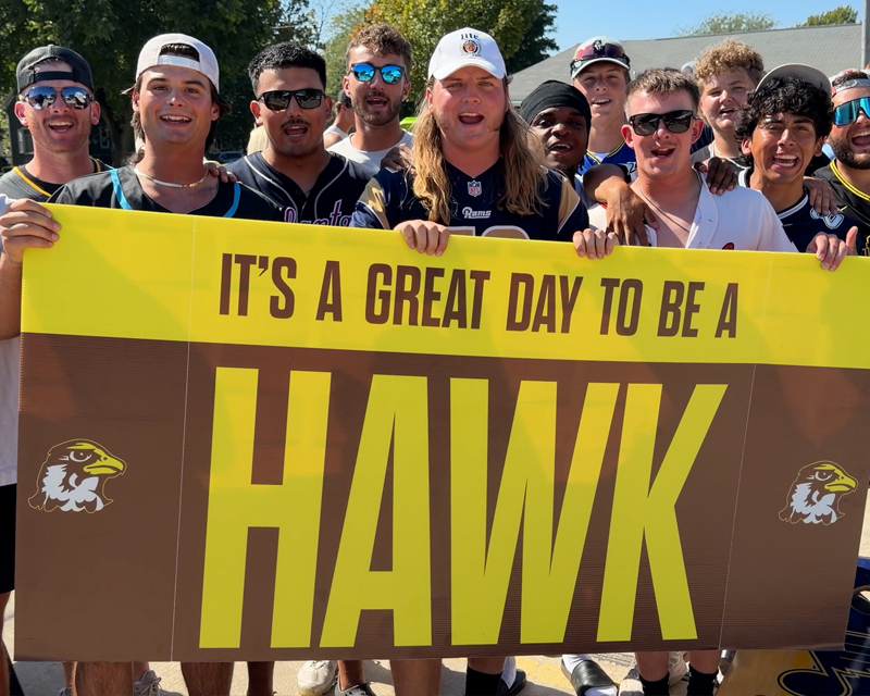 male students holding a sign 