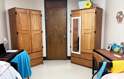 two wooden large closets in dorm room