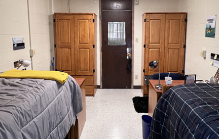 two tall wooden closets in a dorm room