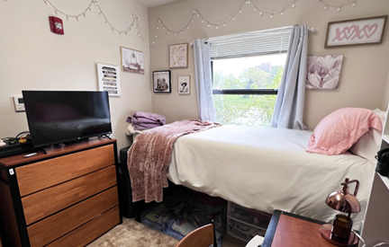 student living center bedroom with bed and dresser