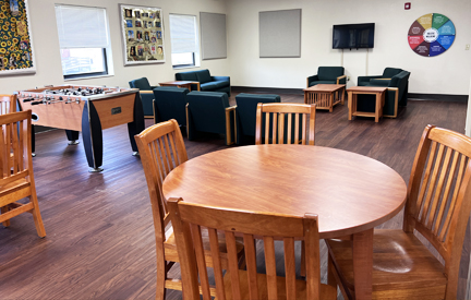community space at student living center dorm with tables and couches