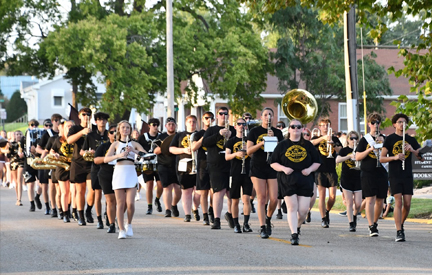 QU band walking down the street during Homecoming parade
